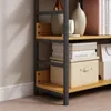 A close-up view of a bookshelf with books and decorative items. Produktbild-Vorschau