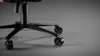 A close-up shot of the base and wheels of a black office chair. Náhľad obrázku produktu