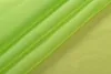 A close-up shot of draped green fabric. Produktbild-Vorschau