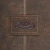 A close-up of a brown leather patch with an embossed logo on a textured brown leather surface. Produktbild-Vorschau