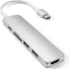 A silver USB-C hub with multiple ports and a white cable connected to a USB-C connector, shown on a white background. Voir les images du produit