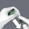 Hands wearing white gloves are holding a tool and a small electronic device. An arrow indicates a downward motion. Produktbild-Vorschau