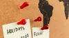 A close-up view of a corkboard with a world map, notes, and red pushpins. Produktbild-Vorschau