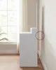 A white vanity with a mirror against a light-colored wall, next to a window with sheer curtains. Náhled obrázku produktu