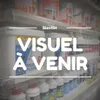 Shelves in a store with various products, including paint cans and bottles. Voir les images du produit