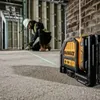 A construction worker is using a laser level on a concrete floor. Produktbild-Vorschau