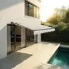 A modern house with a retractable awning extended over a patio area next to a swimming pool. Produktbild-Vorschau