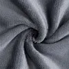 A close-up, textured view of a soft, gray fabric, likely a blanket or bedsheet, with folds and creases creating a swirling pattern. Produktbild-Vorschau