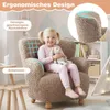 A young girl sitting on a fluffy brown child's armchair, holding a stuffed bunny. The background shows a child's room with a bookshelf and a teepee. Produktbild-Vorschau