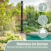 An outdoor shower next to a swimming pool in a garden setting. Produktbild-Vorschau