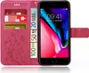 A pink flip phone case with a floral design, open to reveal an iPhone 8 screen displaying the time and date. Credit cards and euro banknotes are visible in the case's card slots. Produktbild-Vorschau
