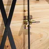 A close-up view of a wooden table's underside, showing a metal latch mechanism and part of a black metal leg. Anteprima dell’immagine prodotto
