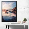 A framed poster of the Golden Gate Bridge is displayed on a wall above a desk with a laptop and a small plant. Produktbild-Vorschau