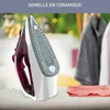 A close-up shot of a purple and white iron on a table, with clothes in the background. Voir les images du produit