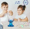 Two children are playing with a Stitch plush toy and cards on a table. Náhľad obrázku produktu