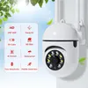 A white security camera with features listed on a graphic overlay, set against a bright sky and green leaves. Produktbild-Vorschau
