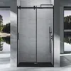 A modern bathroom with a black framed sliding shower door. Produktbild-Vorschau
