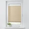 A cream-colored pleated blind is installed in a white window frame, with a small potted plant and three glasses on the windowsill below. Produktbild-Vorschau