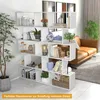 A white, multi-level bookshelf filled with decorative items and books, placed in a living room setting next to a brown leather sofa and a potted plant. Anteprima dell’immagine prodotto