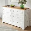 A white dresser with a wooden top, decorated with a bowl of green apples and a green vase with flowers. Anteprima dell’immagine prodotto