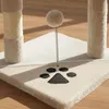 A close-up view of a beige cat scratching post with a paw print detail and a dangling toy. Podgląd zdjęcia produktu