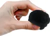 A hand is holding a black filter ball. Voir les images du produit