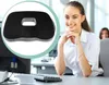 A woman is sitting at a desk in an office environment, with a product image of a seat cushion superimposed on the left side of the image. Produktbild-Vorschau