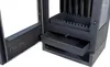 Close-up view of the interior of a black wood-burning stove, showing an open ash drawer and the fire grate. Produktbild-Vorschau