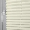A close-up view of a beige pleated blind with a white window handle. Produktbild-Vorschau