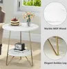 A round, two-tiered side table with a marble-like finish and gold legs, decorated with a cake and flowers. Anteprima dell’immagine prodotto