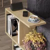 A side table next to a sofa, holding a smart speaker, remote, and a cup of tea. Podgląd zdjęcia produktu