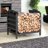 A black metal firewood rack filled with logs is placed next to a stone fireplace. Náhľad obrázku produktu
