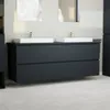 A modern bathroom vanity with two sinks and faucets, set against a plain wall with mirrors above. Produktbild-Vorschau