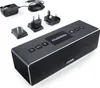 A Canton Musicbox XS portable Bluetooth speaker with various power adapters. Produktbild-Vorschau