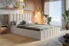 A bedroom scene with a bed, nightstand, and plants. Náhled obrázku produktu