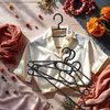 A flat lay of clothing and accessories on a wooden surface. Anteprima dell’immagine prodotto