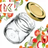 A clear glass jar with a gold lid, surrounded by fresh vegetables and herbs. Podgląd zdjęcia produktu
