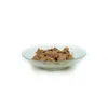 A close-up shot of wet dog food in a clear bowl, isolated on a white background. Produktbild-Vorschau