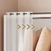 A white curtain hanging from a curtain rod, with pillows in the background. Podgląd zdjęcia produktu