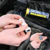Hands mixing a two-part epoxy putty in front of a car engine. Produktbild-Vorschau