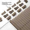 A collection of pleated blind components and a section of the pleated blind itself, laid out on a white background. Produktbild-Vorschau