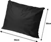 A black pillow with dimensions indicated by arrows and text. Voir les images du produit