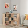 A corner of a room with a wooden bookshelf, artwork on the wall, and a sofa with cushions. Produktbild-Vorschau