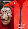 A collage showing a Salvador Dali mask and a close-up of a red overall with a zipper. Produktbild-Vorschau