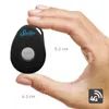 A hand is holding a small black GPS tracker device. Produktbild-Vorschau
