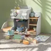 A wooden toy coffee and ice cream bar set with various accessories laid out on a carpeted floor. Anteprima dell’immagine prodotto
