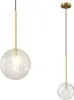 Two pendant lights with clear glass globes and gold metal accents against a white background. Anteprima dell’immagine prodotto