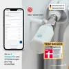 A smartphone displaying a heating schedule next to a smart radiator thermostat attached to a radiator. Produktbild-Vorschau