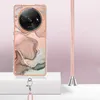 A phone case with a marble pattern and a lanyard, displayed on a white platform against a light pink background. Náhled obrázku produktu