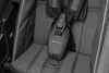 A close-up view of a child's safety harness in a stroller or trailer. Produktbild-Vorschau